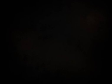 Karanlık gökyüzünde dolunay ve birkaç bulut.