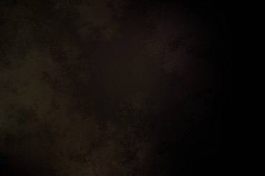 Siyah bir arka planın önünde duran takım elbiseli ve kravatlı bir adam.