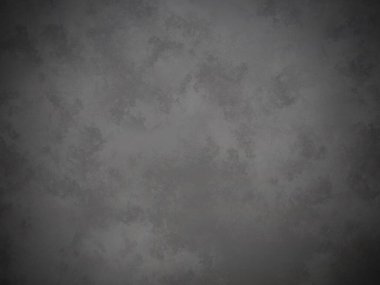 Koyu gri bir duvar ve kirli bir dokusu var.