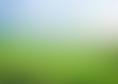 Yeşil çimenler ve gökyüzü ile bulanık arkaplan.