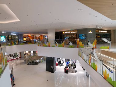 Çin, Shenzhen - 25 Ekim 2024: Shenzhen, Çin 'de modern bir alışveriş merkezi, çeşitli seviyelerde, parlak tasarım ve dekoratif unsurlarla geniş bir açık avlu sergiliyor..