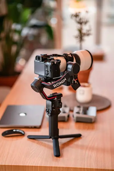 stock image professional digital camera and tripod for recording video on laptop