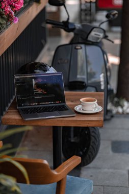 Sokakta dizüstü bilgisayar ve bir fincan kahve