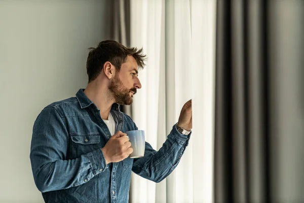 Stock image Man drinking coffee near window,looking outdoor.Coffee time.