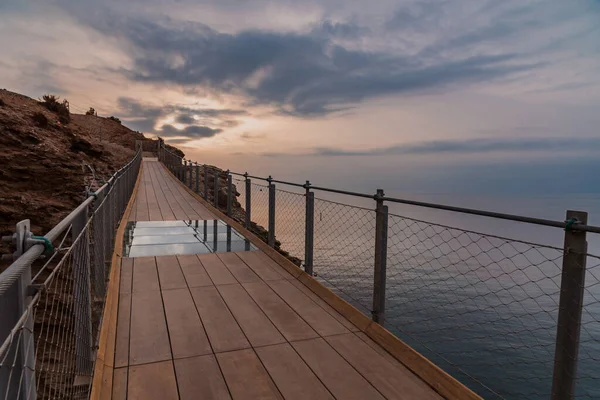 stock image Jolucar suspension footbridge, in Torrenueva Costa, Granada, view of the footbridge over the Mediterranean Sea at dawn.