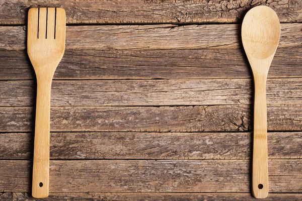 stock image Wooden spoon and fork on old rustic wooden table.