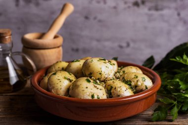 Çiğ mantarlar kil pişirme kabında, baharatlı ve fırına girmeye hazır.. 