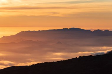 Landscape of the peaks of the Sierra de Tejeda,Almijara and Alhama between shadows and clouds at sunset seen from Sierra Nevada.