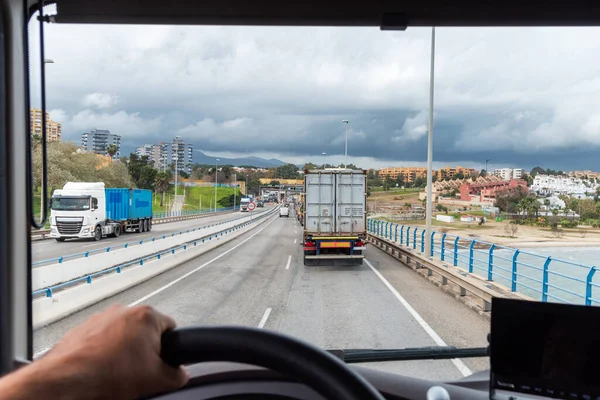 View from the driving position of a truck of the line of trucks to leave the port of Algeciras.