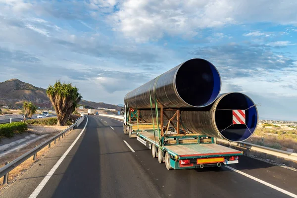 Truck transporting pipes for the gas and oil industry.
