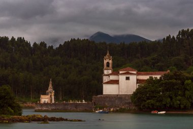 Church of Our Lady of Sorrows and the parish cemetery in the council of Llanes, next to the Barro estuary. clipart