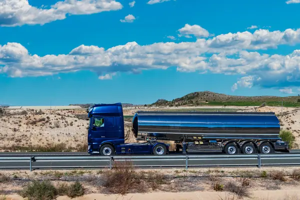 Tanker truck for transporting food liquids traveling on a highway.
