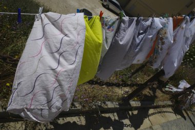 Elbiseleri asmak, güneşte kurutmak.