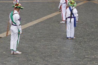 Basque folk dancers in an outdoor festival clipart