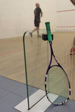 Playing squash at the court clipart