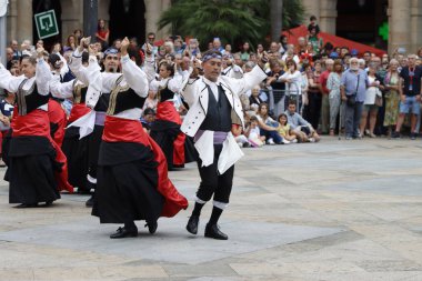 Basque folk dancers during an outdoor festival clipart