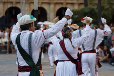 Basque folk dancers in the street during a performance clipart