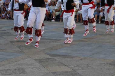 Basque folk dancers in the street during a performance clipart