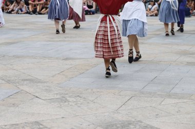 Basque folk dance in an outdoor festival clipart