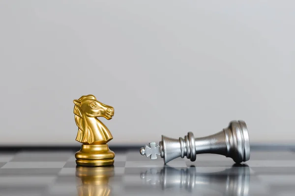 chess game gold horse standing in front  falling silver king. strategic of leadership success. business strategy concept.