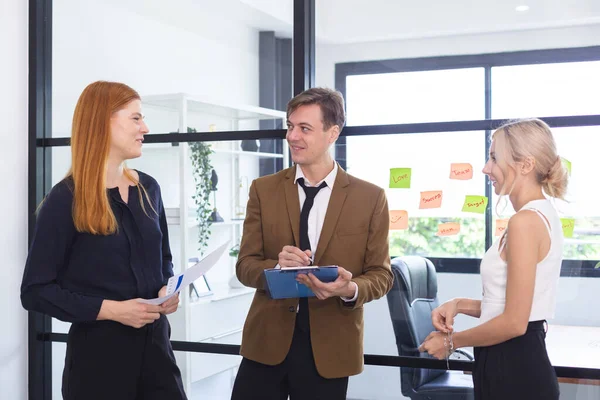 stock image Businessman holding clipboard hands talking meeting with businesswoman in coworking office. businessperson brainstorming strategy.