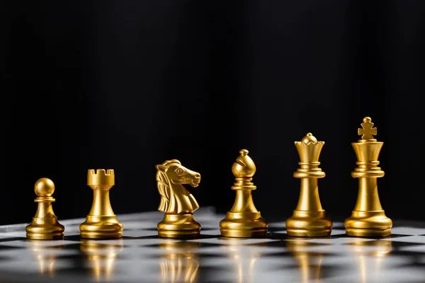 Chess game gold team standing on board. strategic business leadership successful teamwork. business leader concept. strategy challenge business of successful.
