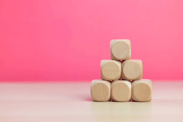 Stock image Stack wooden block cube pink background, successful growing business concept.