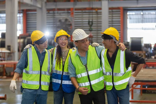 Happy group of various nationalities engineer professional successful team corporate teamwork technician inspector manufacturing industry workplace. Full team heavy industrial factory concept.