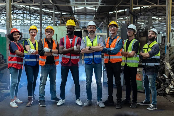 Group of various nationalities engineer professional successful team corporate workers standing in factory. teamwork technician inspector manufacturing industry workplace. Full team heavy industrial factory concept.