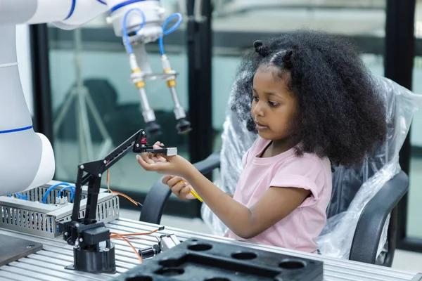 children girl with afro hairstyle robotics class for education on table at class room.  learning innovation electronic for future AI. electric system skill training. STEM education concept.