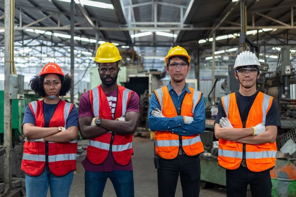 Engineer professional successful team corporate workers crossed arms standing in factory. teamwork technician inspector manufacturing industry workplace.