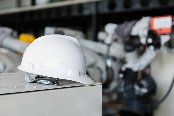 White helmet or hard hat for head safety in industry factory. equipment safe of worker construction. Futuristic industry production manufacturing.