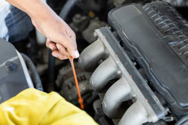 Tamirci oto tamircisi motor yağını kontrol ediyor. Adam işçi tamirci tamirhanesi. Ulaşım onarım hizmeti kavramı.