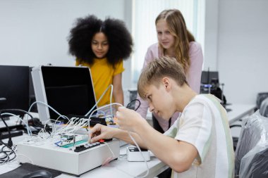 Çocuk elektrikli aletleri tamir etmeyi öğreniyor. Eğitim sınıfın masasında, Robotik öğrenme yeniliği. Elektrik sistemi eğitimi. BTMM eğitim kavramı.