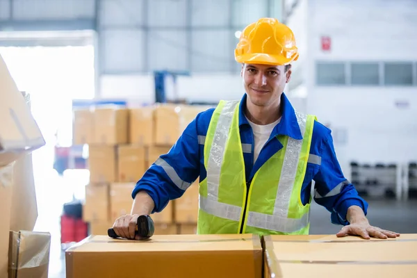 倉庫の棚に安全制服とハード帽子の労働者のパッケージボックス製品を身に着けている男のプロの労働者 男性労働者貯蔵物流製品 — ストック写真