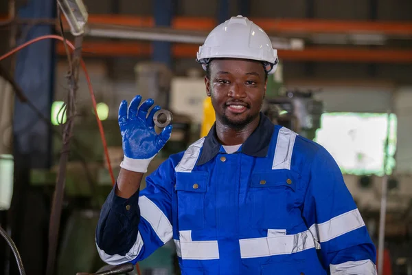 Portrait male african american worker happy smiling wear hardhat standing at factory industrial. Engineering worker man work machine lathe metal. Heavy industry concep