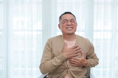 Orta yaşlı bir erkeğin göğsüne dokunması kalp hastalığına neden olur. Sağlık ve insan kavramı. Yaşlı adamın kalbi ağrıyor. tedavi acı nefes.