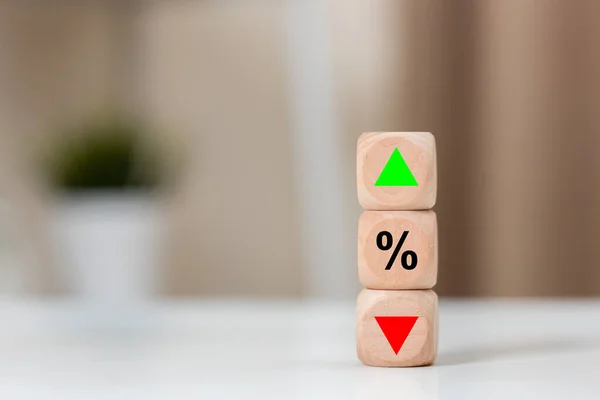Investment market risk up or down concept. wooden cube block with percentage arrow high to low symbol icon.