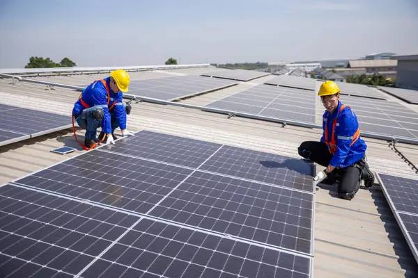 Engineer set installing and inspect standards of solar panels on roof of an industrial factory. Team technician inspection and repair technology solar cell. Alternative innovation power environmental.