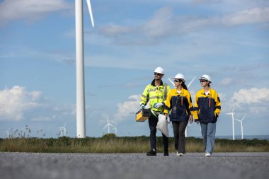 Engineer wearing safety uniform discussed plan about renewable energy at station energy power wind turbine. technology protect environment reduce global warming problems. clipart