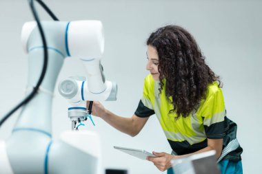 Endüstriyel laboratuvar fabrikasında uzaktan kumandalı otomasyon robotları kullanan teknisyen mühendisi. Kadın teknolojik araştırma ve geliştirme fabrika yenilikçi otomasyon robotu.