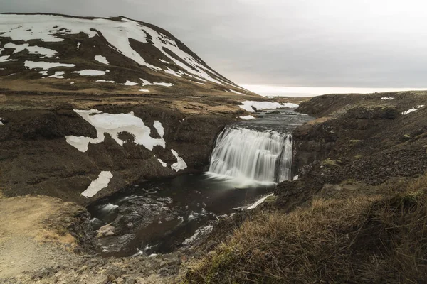 Iceland landscape with waterfall in winter
