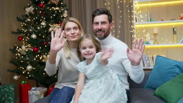 陽気な家族の両親と小さな女の子の子供がリモートでビデオ会議チャットコールを迎えるオンライントークお祝いメリークリスマス新年の冬の休日は カメラのウェブカメラのビューを見て — ストック動画