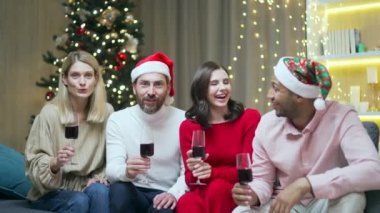 Genç neşeli grup üyeleri, arkadaşlar evlerinde şarap kadehlerini tokuştururken evdeki kanepede oturarak yeni yılı kutluyorlar. Birbirlerine mutlu Noeller diliyor ve birlikte sarılıp eğleniyorlar.
