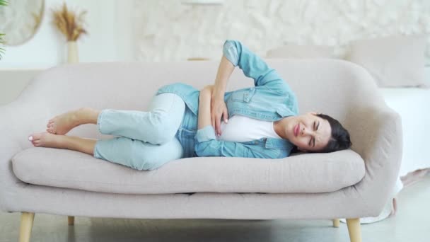 Sick Dark Haired Woman Suffering Stomach Ache Laying Couch Holding — Stock Video