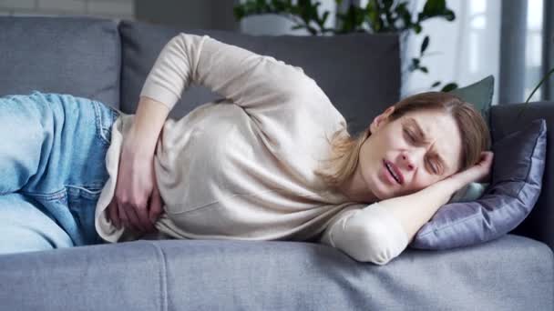 Sick Young Blond Woman Suffering Stomach Ache Laying Couch Holding — Stock Video