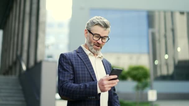 Überglücklicher Älterer Geschäftsmann Hält Smartphone Und Feiert Sieg Karrierewachstum Erfolgreichen — Stockvideo