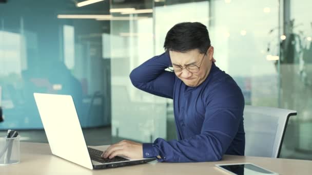 Overworked Tired Asian Businessman Programmer Glasses Suffers Severe Pain Muscles — Stock Video