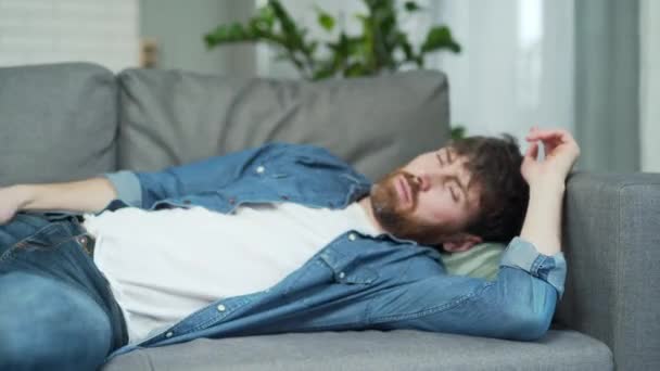 Portrait Drunk Bearded Man Sleeping Couch Home Bottle Next Him — Stockvideo