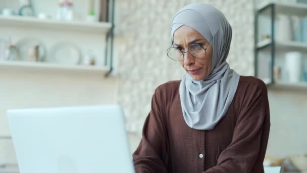 中毒や中毒の若いイスラム教徒の女性は悪い感じ ヒジャーブの女性は ラップトップコンピュータで自宅で働いている間 吐き気や嘔吐に苦しんでいます 室内不健康な妊娠症候群 — ストック動画